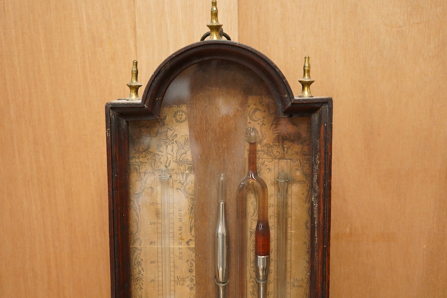 A George III mahogany multi-tube barometer together with integral thermometer by Sala, London, in a mahogany glazed case with arched pediment and three brass finials, paper scales with maker’s mark, height 61cm. Conditio